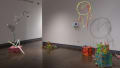 The second gallery with colorful sculptural pieces, along the floor and hung from the ceiling.