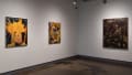A corner in the SVA Chelsea Gallery with three paintings on the wall.