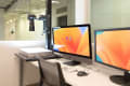 A workstation with two monitors and a dlsr scanner