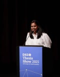 Person speaking at podium with text reading DSI Thesis Show 2025