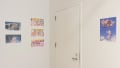 Brightly colored series of six illustrative prints hang on the wall near the corner of the gallery. 