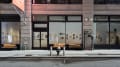 Street view of the SVA Flatiron Gallery in SVA’s 133/141 West 21st Street building. The colorful illustrative posters can be seen through the building windows. 