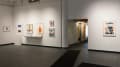  In the SVA Gramercy Gallery, several colorful collages of various sizes hang on a wall left of the doorway. To the right of the doorway there is a single, large, framed collage which resembles a person’s head.