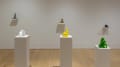 Six sculptures rest on pedestals and wall mounted ledges in the gallery space. 