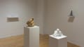 Four 3D printed sculptures displayed on the walls and standing pedestals in the gallery space.