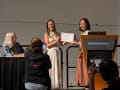 A woman is photographed while receiving an award