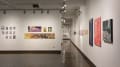 Multiple views of SVA Chelsea Gallery. There is illustrations and paintings hung on the walls. There are multiple shelves throughout the gallery with books places on them.