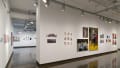 Multiple views of SVA Chelsea Gallery. There is illustrations and paintings hung on the walls. There are multiple shelves throughout the gallery with books places on them.