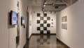 Multiple views of SVA Chelsea Gallery. There are photographs hung on the wall, installations and projections throughout the gallery. 