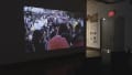 Multiple views of SVA Chelsea Gallery. Posters are hung on the walls. The second gallery has two projections on opposite walls with chairs in the center. 