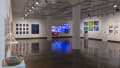 Multiple views of SVA Chelsea Gallery. There are illustrations, monitors, and paintings hung on the walls. Shelves have posters, books, CDs and artist take-aways.