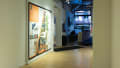 Exhibition view of An Infrastructure for Restorative Justice, featuring hallway with a large poster on the wall.