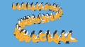 A row of women in orange jumpsuits sit and braid each others hair against a blue background. 