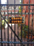 A wrought-iron gate leads into Grove Court.