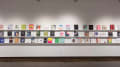 Books are displayed in three rows on long shelves that span the width of gallery four.