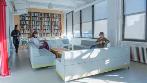Two people reading in MA Curatorial Practice Lounge 