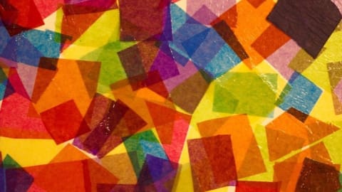 random collage of layered rainbow-colored paper squares.