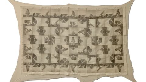 A quilt by Julia Colletes on view in BFA Visual & Critical Studies' Disclosed Studios Part Two. The quilt is made of a pattern of patches featuring an image of a feminine person in various seated positions.