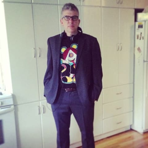 man in suit and graphic t shirt