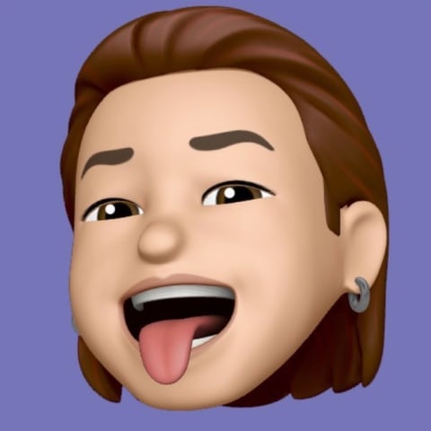 A memoji representation of Kevin Cadena. The memoji has olive toned skin with medium-length brown hair slicked back, brown eyes and brown eyebrows. The memoji has silver earings and is sticking its tongue out. The character is set against a solid purple background.
