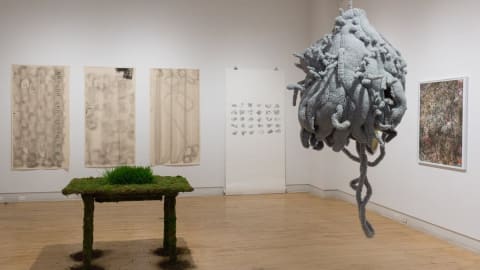 sculpture hanging in a museum type room.