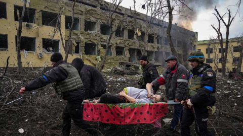 Ukrainian emergency employees and police officers evacuate injured pregnant woman Iryna Kalinina, 32, from a maternity hospital that was damaged by a Russian airstrike in Mariupol, Ukraine, March 9, 2022. (AP Photo/Evgeniy Maloletka)