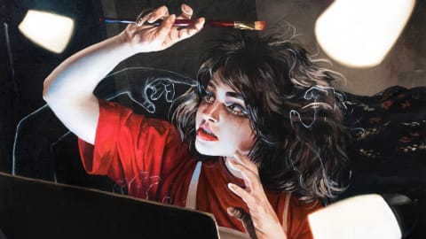 Self-portrait of a young female artist painting while illuminated by various light sources.
