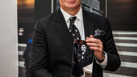 A man holding an award.