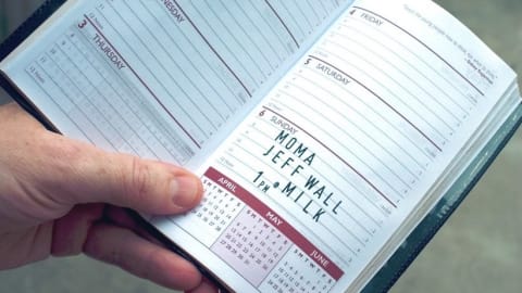 Hands holding a day planner.