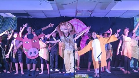 Picture of children performing on a stage.