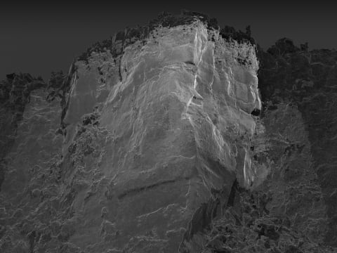 Black and white image of partially eroded mountain.