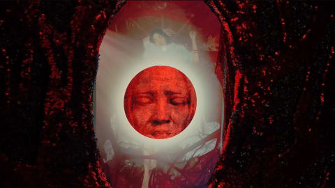 A face inside a red circle sits at the center of dark markings. Projections and translucent layers of human figures surround the circle. 