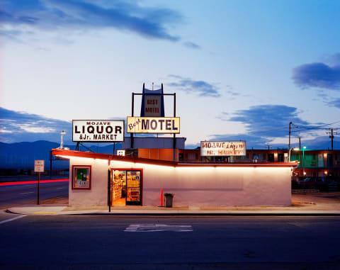 A liquor store photographed as night descends on the small town of Mojave, California