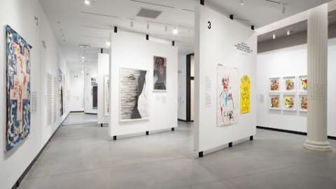An photography of an installation view of the Poster House exhibit, 'Masked Vigilantes On Silent Motorbikes.'