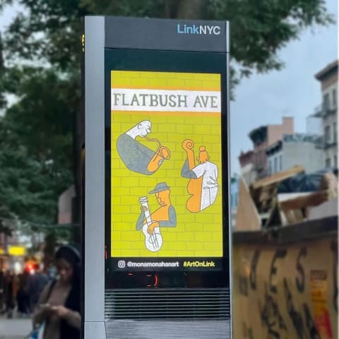 A photo of a LinkNYC terminal with a screen on the side displaying an illustration that reads "flatbush ave" with drawings of people playing instruments on it
