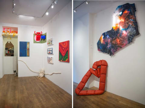 Two images. On left, a photograph of a room with various art pieces hung up and resting on the ground, including a white stuffed animal with long arms, an abstract painting, and a sculptural piece that is jutting off of the wall in the form of a cubist bull head. On the right is a photograph of the same space from a different angle, showing two sculptural pieces, one is a red tube of fabric sewn into segments that all connect in a circle. Above this sculpture is an abstract form created out of transparent sheets of colored paper, there is a light behind it illuminating the piece
