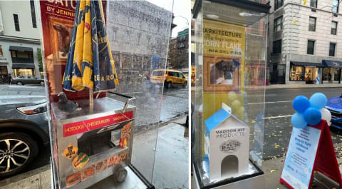 Two photos left to right: a glass case with a dog house in the shape of a hot dog cart inside. A glass case with a doghouse in the shape of a milk carton inside.