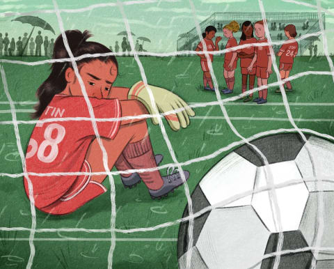 An illustration of a girl sitting in front of a soccer goal in defeat. In the foreground is a soccer ball that has been scored in the net.