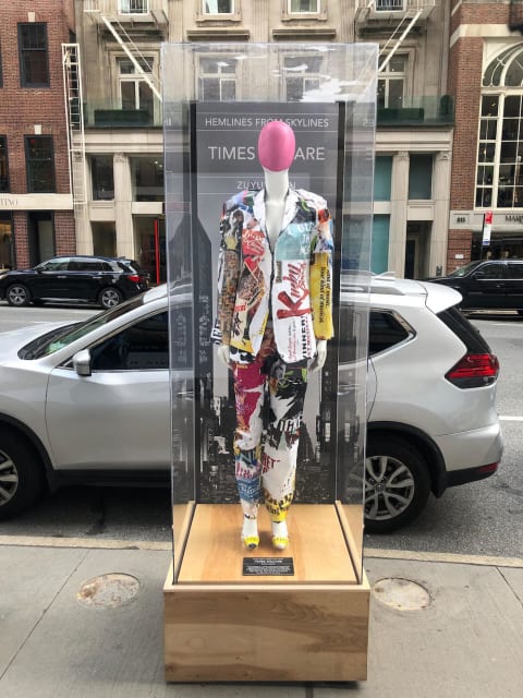 An image of a Times Square-themed garment featured in the new "Hemlines from Skylines: Architectural Fashion" installation on Madison Avenue.
