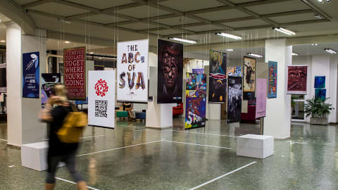 <p "="">A photograph of an exhibition of hanging posters, all advertising the educational offerings of the School of Visual Arts.
