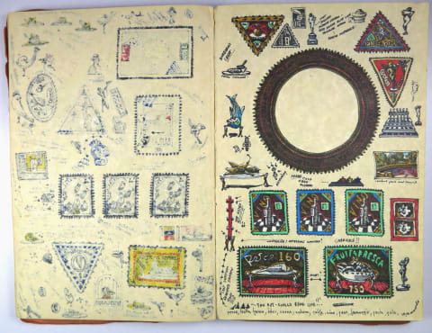 a notebook with old stamps and symbols
