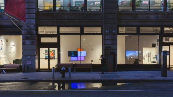 Exterior view of SVA Flatiron Windows. Monitors and paintings are in the windows. 