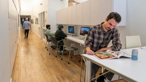 People congregating in an open plan, community oriented lounge.