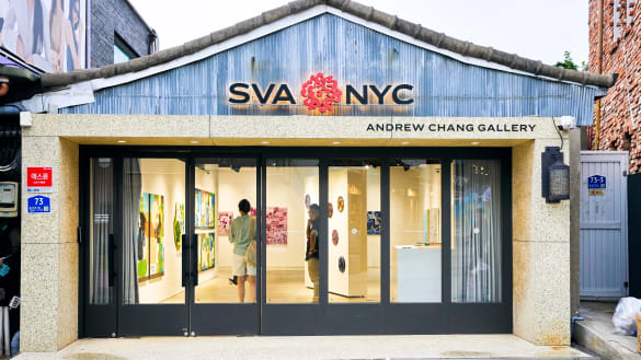 Facade of a brick-and-mortar art gallery in Seoul; it is affixed with signs that say SVA NYC and Andrew Chang Gallery.