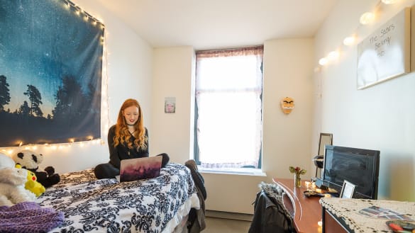Student in a single room in the Ludlow Residence Hall.