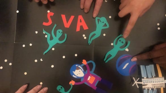 Still from stop-motion animation featuring paper cutouts of aliens and a cat-stronaut