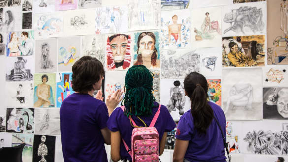 Guest viewing artwork at the Pre-College end-of-year showcase.