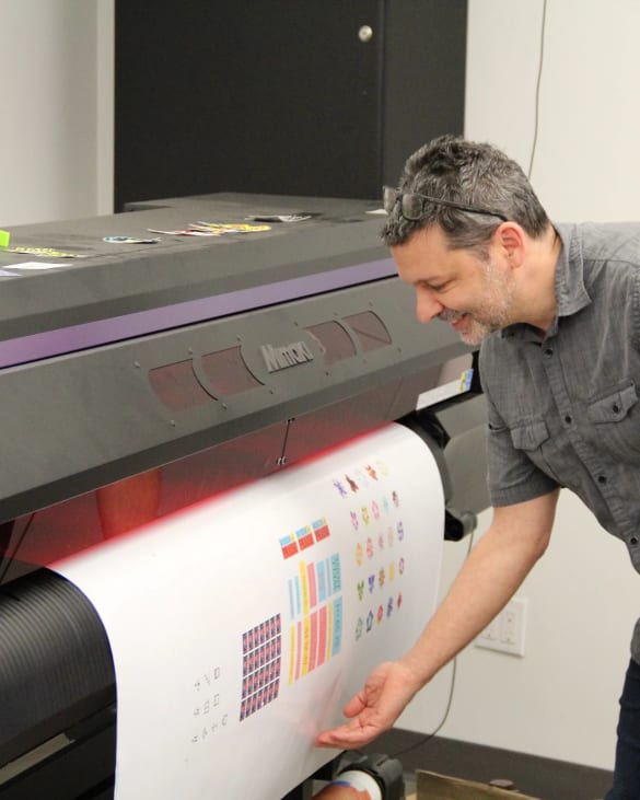 Instructor waiting as a color printer produces a very large sheet.