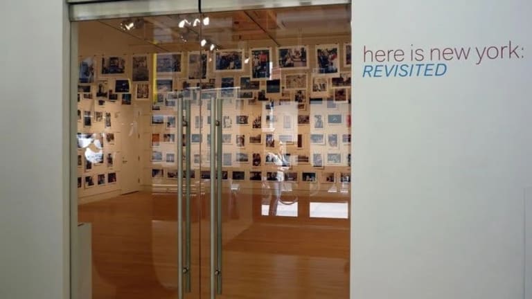 These are the glass front doors to a photo gallery featuring images of New York.