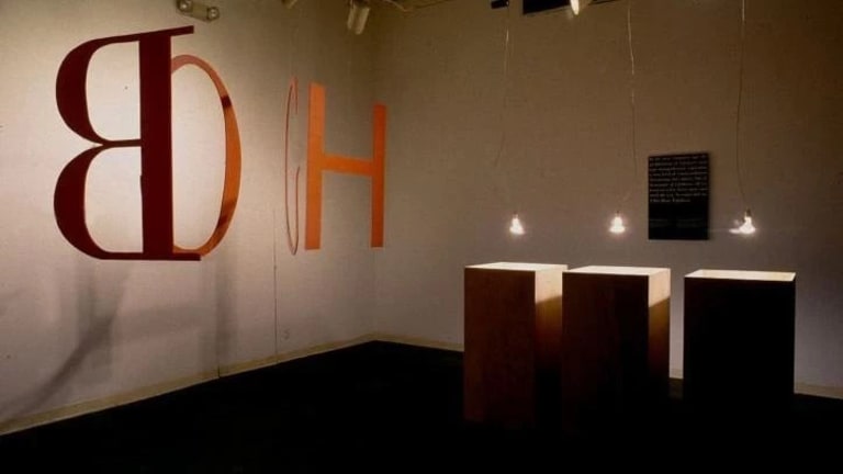 An art showcase containing letters and lights and boxes.